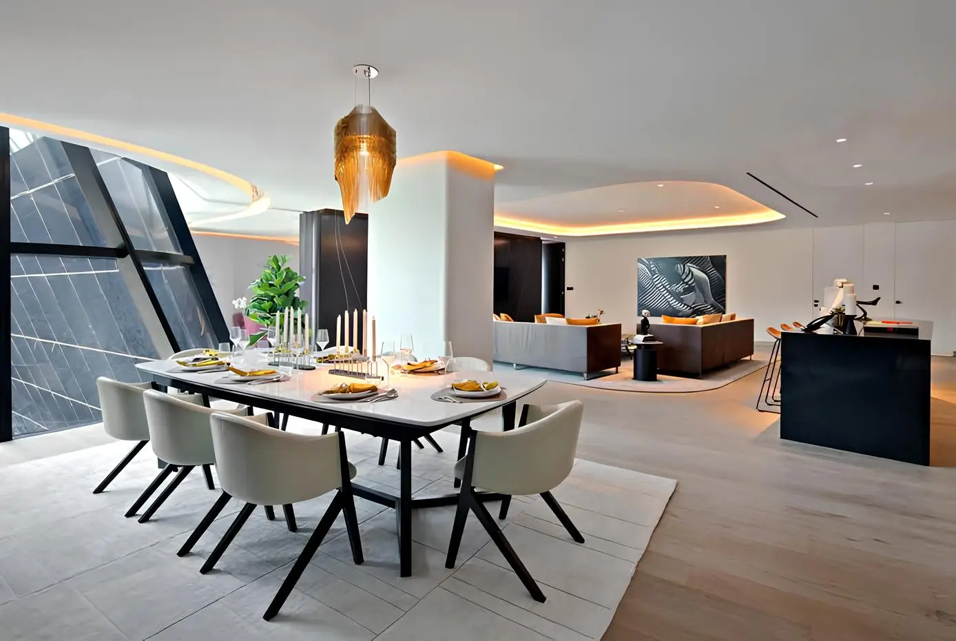 Dining area beside large inclined windows shown in the OMNIYAT "The Opus by Omniyat" catalogue, Dubai