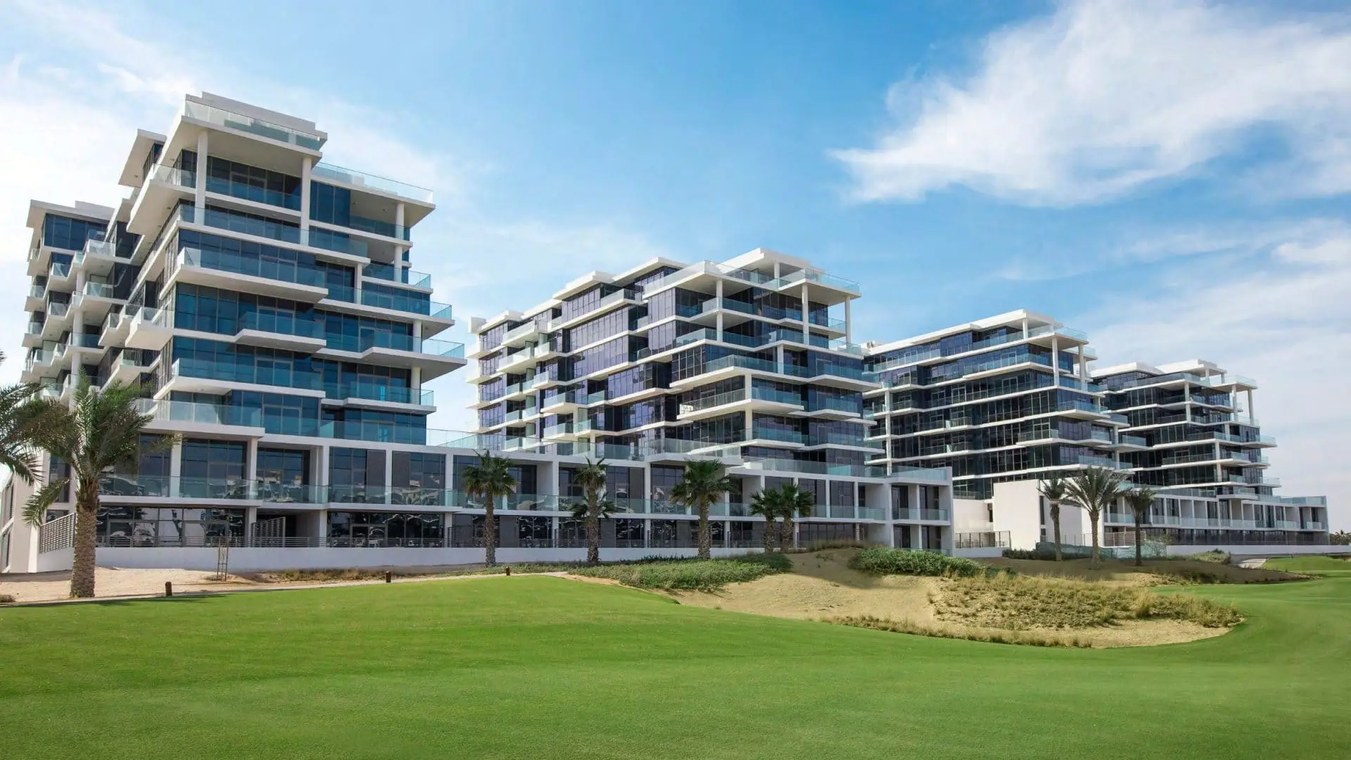 Residential buildings beside landscaped grounds shown in the DAMAC "Golf Terrace" catalogue, Dubai